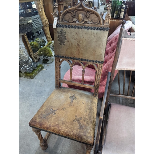 1059 - A pair of Gothic style carved walnut and leather side chairs together with an Edwardian beech foldin... 