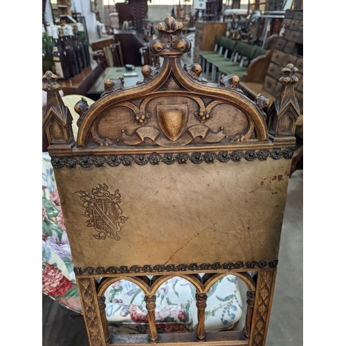 1059 - A pair of Gothic style carved walnut and leather side chairs together with an Edwardian beech foldin... 