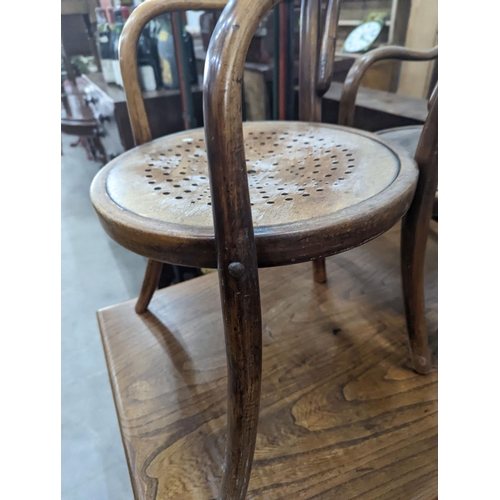 1076 - A near pair of early 20th century beech bentwood childs elbow chairs