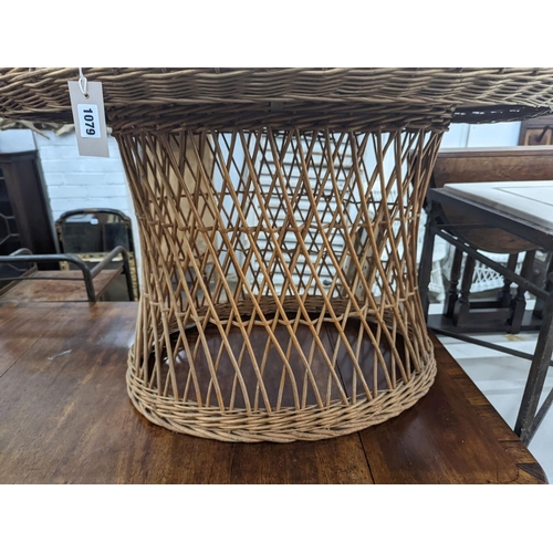 1079 - An oval rattan conservatory table, length 100cm, depth 71cm, height 60cm