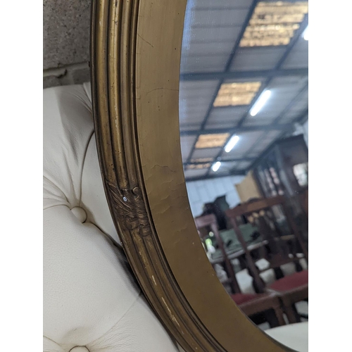 1086 - An Edwardian oval gilt framed wall mirror, width 72cm, height 87cm