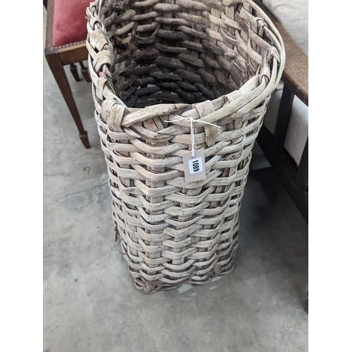 1089 - A vintage woven grape hod, width 48cm, height 64cm