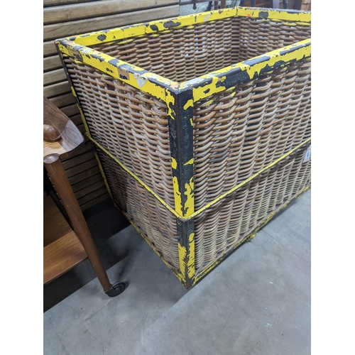 1096 - A vintage wicker and iron laundry basket on wheels, width 85cm, depth 61cm, height 87cm