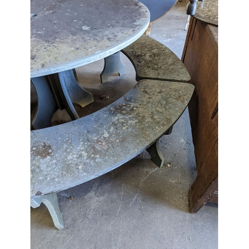 1112 - A heavy slate circular topped garden table, diameter 125cm, height 79cm together with four crescent ... 