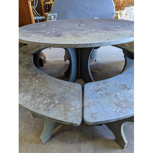 1112 - A heavy slate circular topped garden table, diameter 125cm, height 79cm together with four crescent ... 