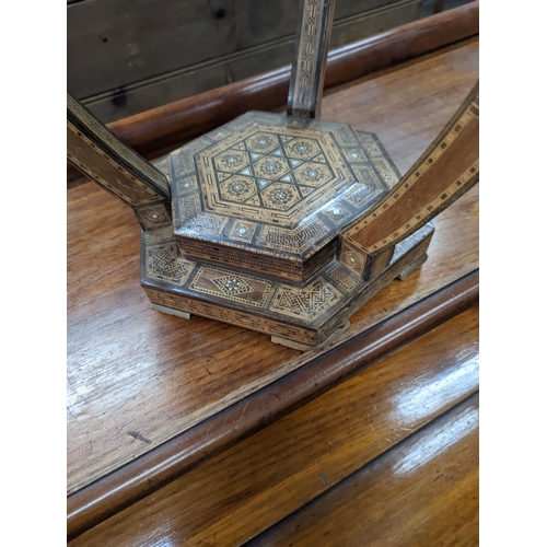 1120 - A Moorish bone and parquetry inlaid two tier occasional table, diameter 41cm, height 52cm... 