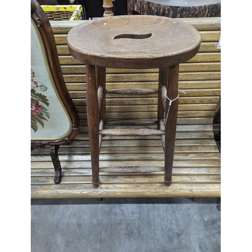 1132 - An elm and beech stool together with a Victorian rosewood tapestry firescreen