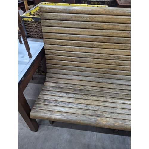 1133 - A vintage slatted wood tram bench, length 140cm, depth 60cm, height 98cm