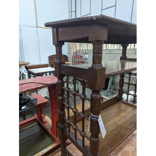 1135 - A late 19th century Continental oak three tier Liberty style table with slant top, width 70cm, depth... 