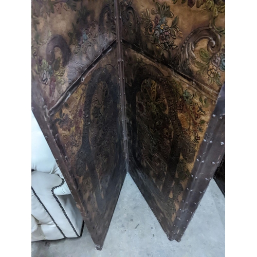 1138 - An embossed leather four fold dressing screen, each panel width 51cm, height 181cm