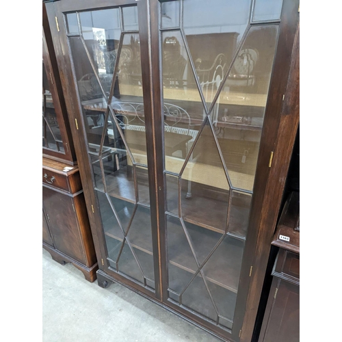 1143 - A reproduction George III style glazed mahogany two door display cabinet, width 108cm, depth 40cm, h... 