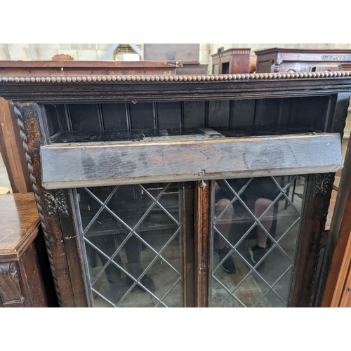 1149 - An early 20th century glazed oak two door bookcase, length 99cm, depth 29cm, height 150cm... 