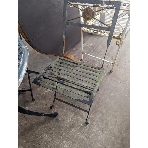 1157 - A circular aluminium garden table, diameter 74cm, height 72cm and four folding chairs