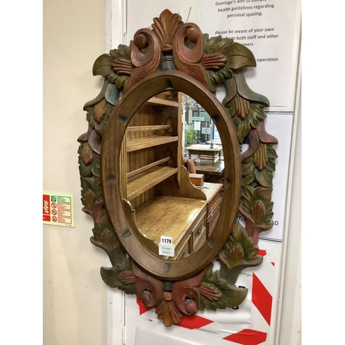 1179 - A Victorian style oval polychrome carved wood mirror width 50 cms, height 78 cms