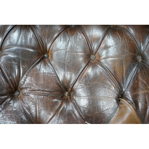 1193 - An early 20th century Chesterfield settee upholstered in deep buttoned brown leather, length 200cm, ... 