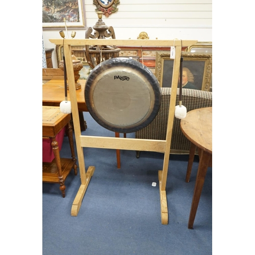 1200 - A Paiste 56cm. gong and a pair of Paiste M3 mallets, on purpose-made oak stand, stand height 124cm... 