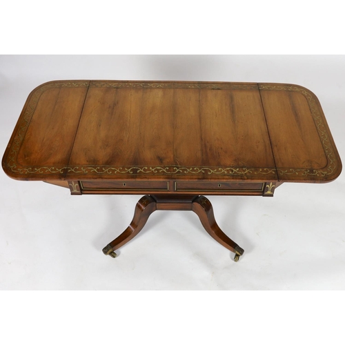 1202 - A Regency brass inset rosewood sofa tableWith D shaped flaps and two freize drawers, on octagonal pe... 