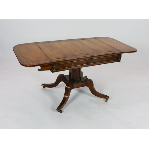 1202 - A Regency brass inset rosewood sofa tableWith D shaped flaps and two freize drawers, on octagonal pe... 