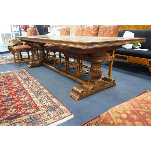 1203 - An 18th century style rectangular walnut refectory dining table on baluster end supports with centra... 