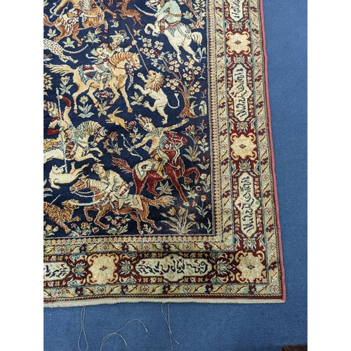 1207 - A Kashan style blue ground pictorial rug, 224 x 144cm