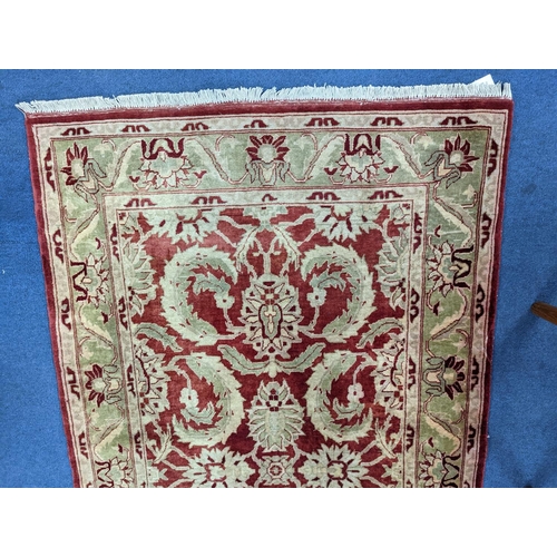 1208 - A Zeigler red ground rug, 160 x 100cm