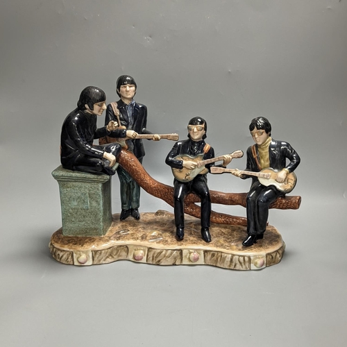 1258 - A large pottery figure group The Legends of Rock & Roll, The Beatles at Hyde Park 37cm long... 