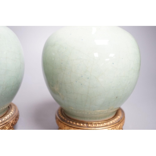 1259 - A pair of Chinese celadon crackle glazed bottle vases with gilt metal stands total height 27cm, base... 