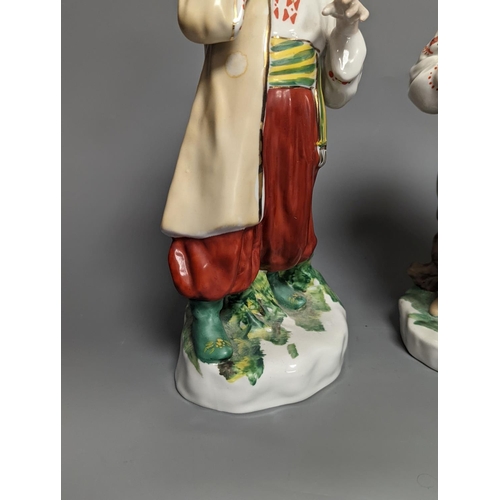 1261 - A pair of Russian porcelain figures of a Cossack and his wife 25cm