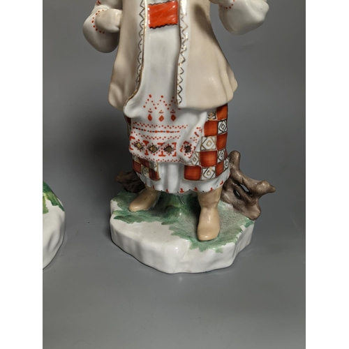 1261 - A pair of Russian porcelain figures of a Cossack and his wife 25cm