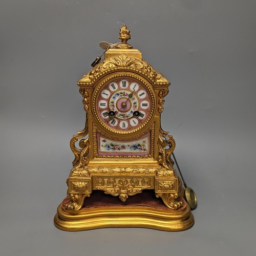 1264 - A 19th century gilt metal mantel clock on plinth with key and pendulum 30cm