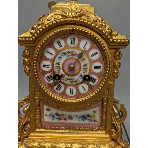 1264 - A 19th century gilt metal mantel clock on plinth with key and pendulum 30cm