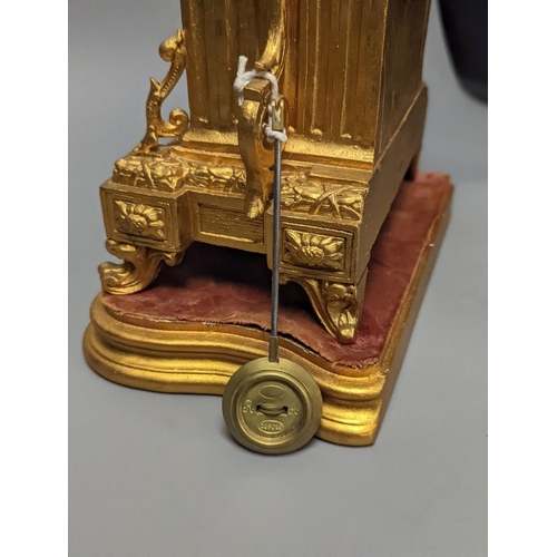 1264 - A 19th century gilt metal mantel clock on plinth with key and pendulum 30cm