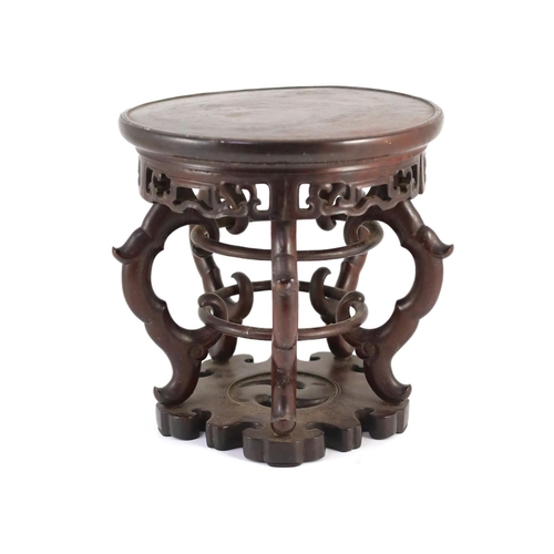 1269 - A Chinese hardwood stand, 19th century,the circular dish top above a fretted frieze, on four scrolle... 