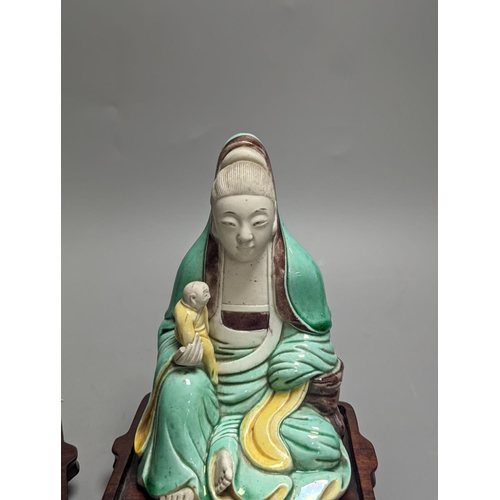 1298 - An 18th century Chinese sancai biscuit group of Guanyin with child and a 19th century Chinese sancai... 