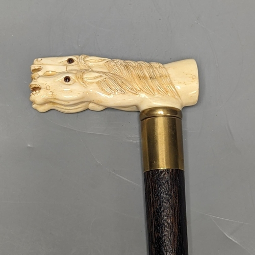 1303 - A bone 'horse head' handled walking stick 90cm