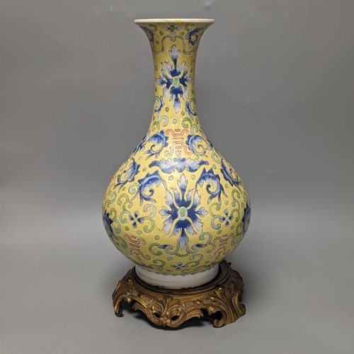 1305 - A Chinese yellow ground vase, raised on a gilt bronze base 38cm