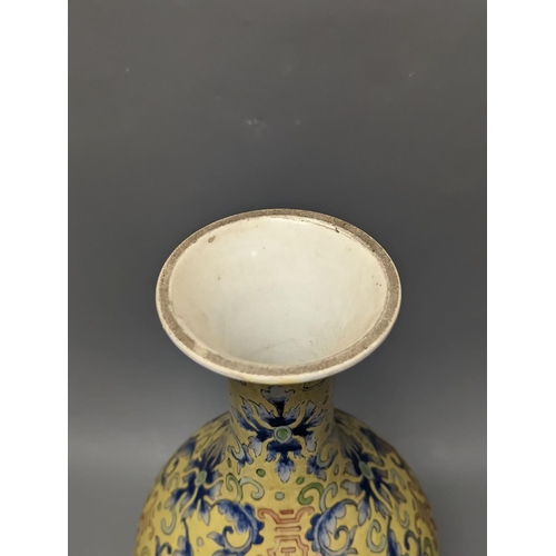 1305 - A Chinese yellow ground vase, raised on a gilt bronze base 38cm