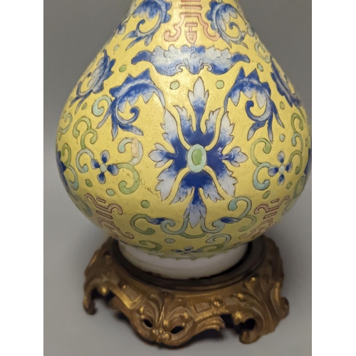 1305 - A Chinese yellow ground vase, raised on a gilt bronze base 38cm