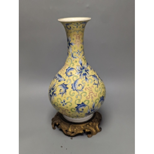 1305 - A Chinese yellow ground vase, raised on a gilt bronze base 38cm