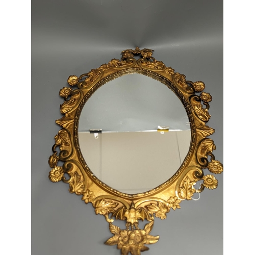 1314 - A pair of gilt brass wall mirrors, decorated with bats and flowers 56cm