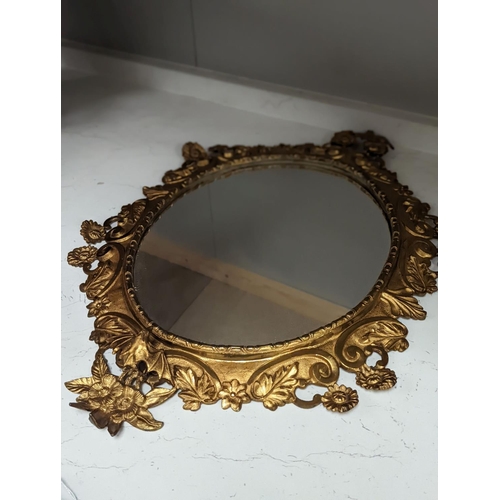 1314 - A pair of gilt brass wall mirrors, decorated with bats and flowers 56cm