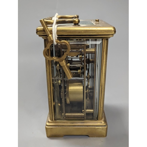 1333 - A brass cased carriage clock, with key. 16cm