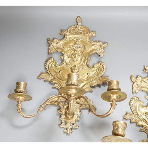 1362 - A pair of French ornate brass three branch wall sconces,37 cms high,