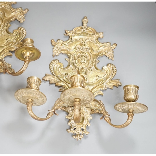 1362 - A pair of French ornate brass three branch wall sconces,37 cms high,