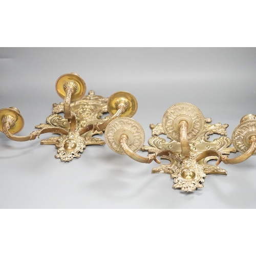 1362 - A pair of French ornate brass three branch wall sconces,37 cms high,