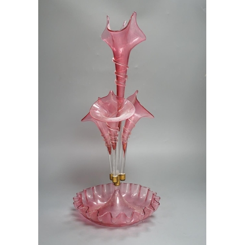 1365 - A Victorian cranberry glass four vase table centrepiece,52 cms high.