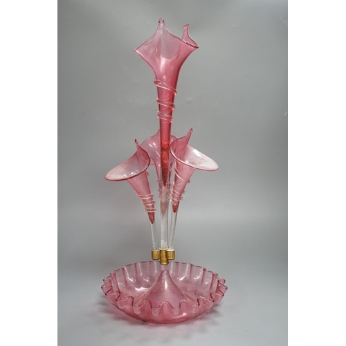 1365 - A Victorian cranberry glass four vase table centrepiece,52 cms high.