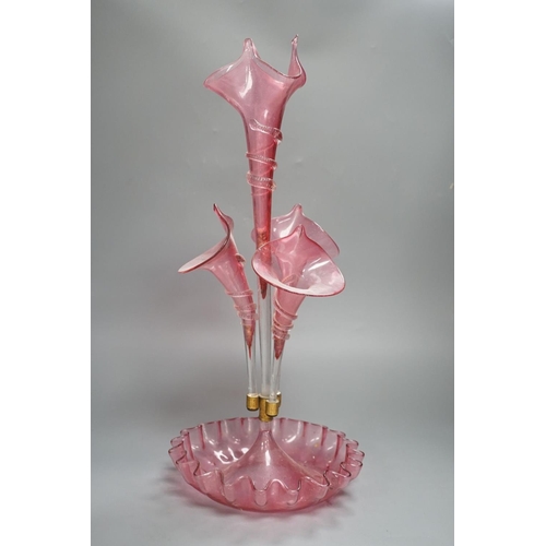 1365 - A Victorian cranberry glass four vase table centrepiece,52 cms high.