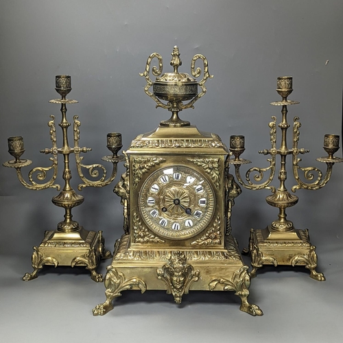 1374 - A 19th century French ornate brass clock garniture including a pair of 3 branch candelabraClock 42 c... 