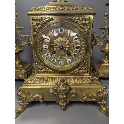 1374 - A 19th century French ornate brass clock garniture including a pair of 3 branch candelabraClock 42 c... 